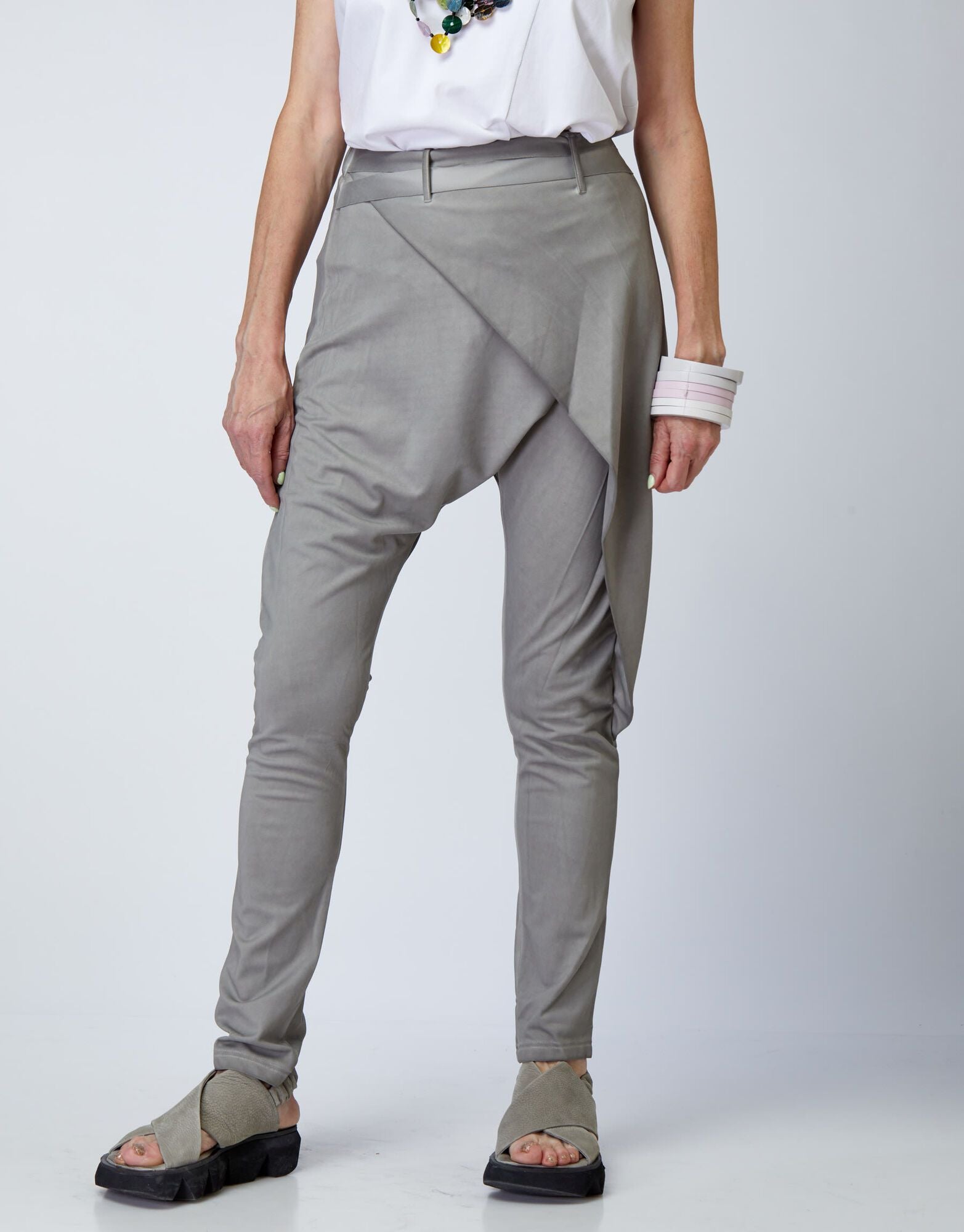 A pair of high-waisted baggy pants and a light gray cord belt 