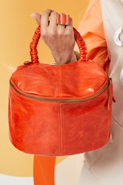 Small leather bag handle with orange shrinks