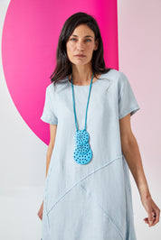 Necklace of blue perforated coconut discs