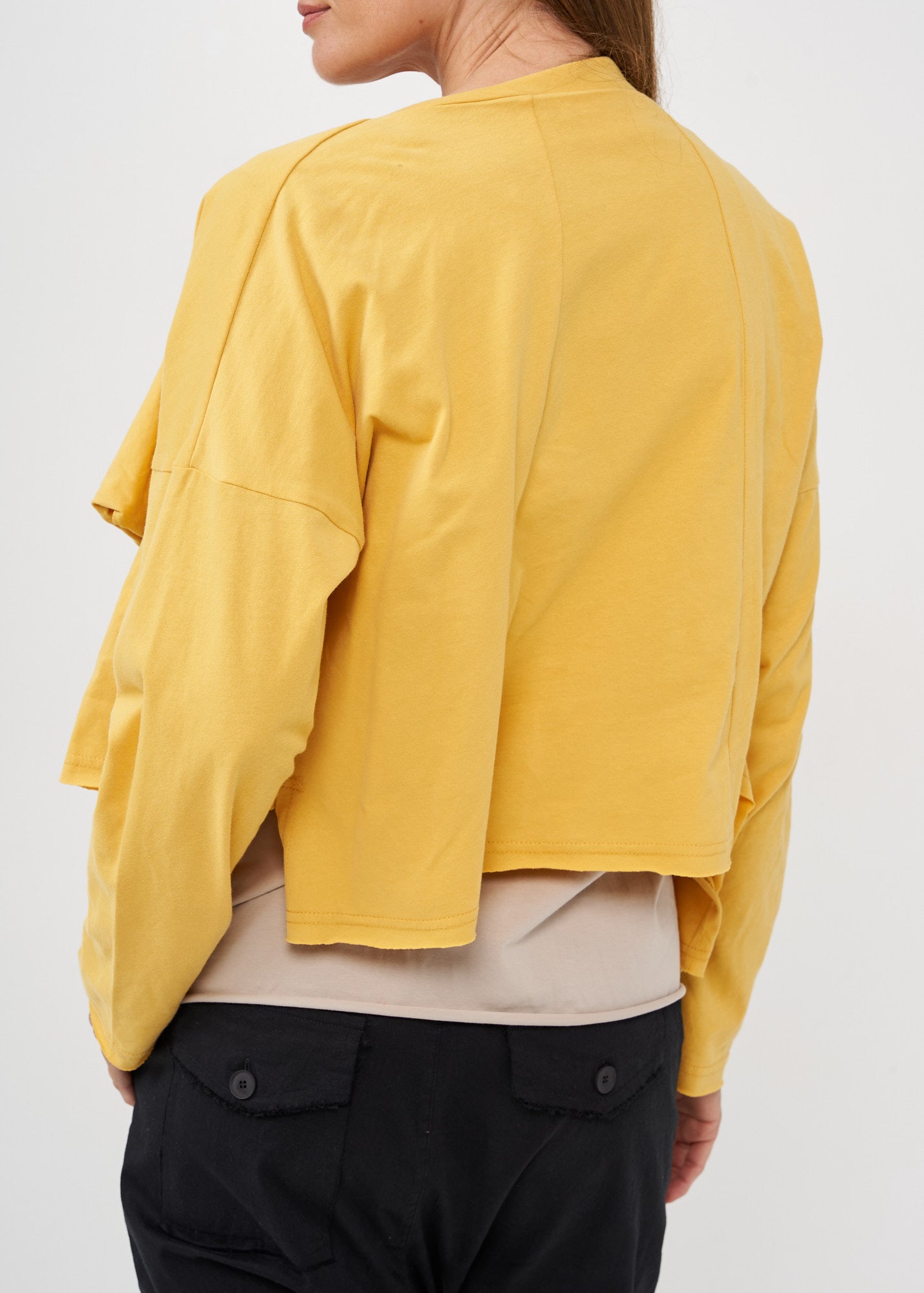 A thin top with a mustard wrapped scarf