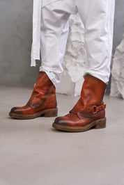 Leather boots with a ring and orange studs