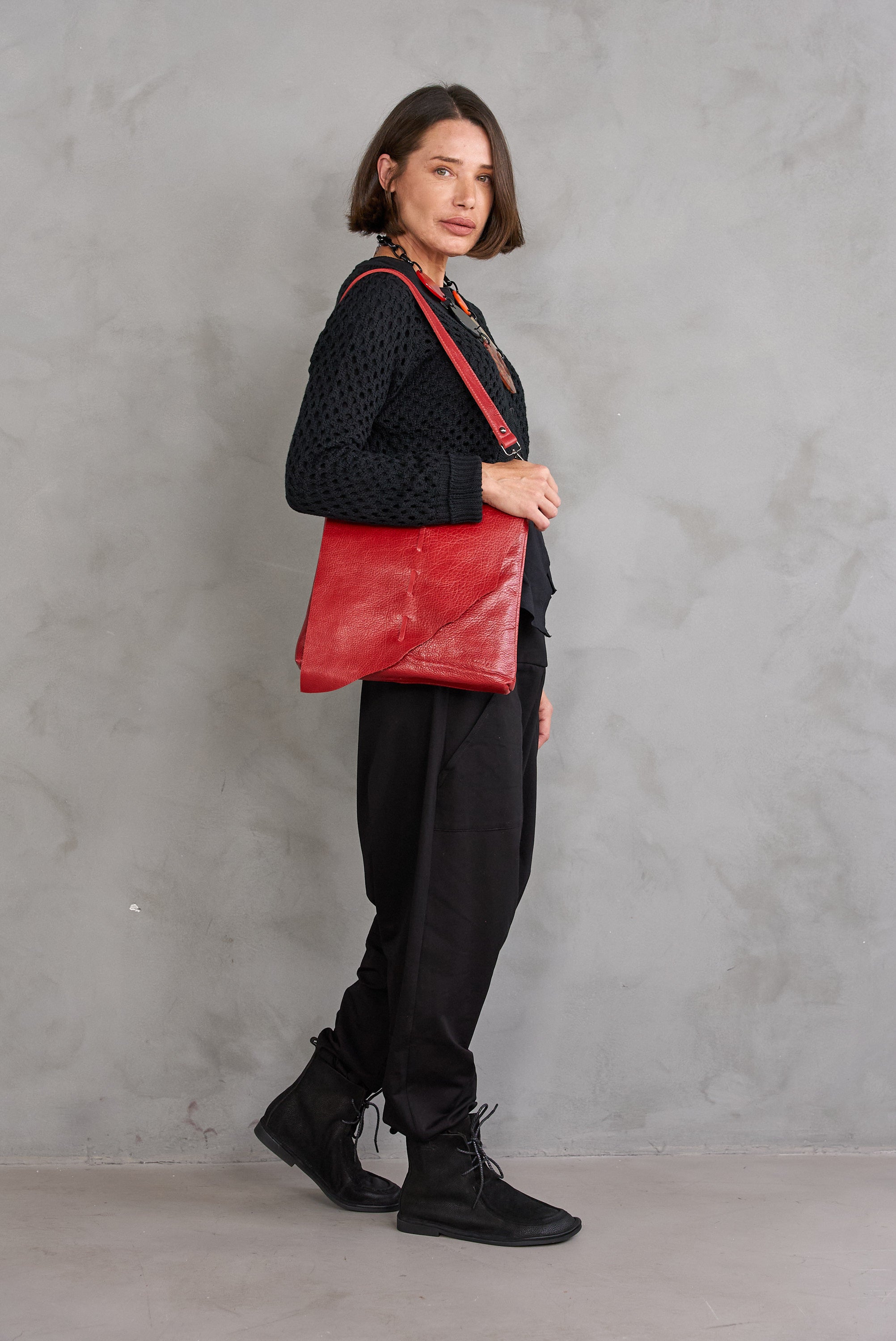 Red asymmetric cut side leather bag