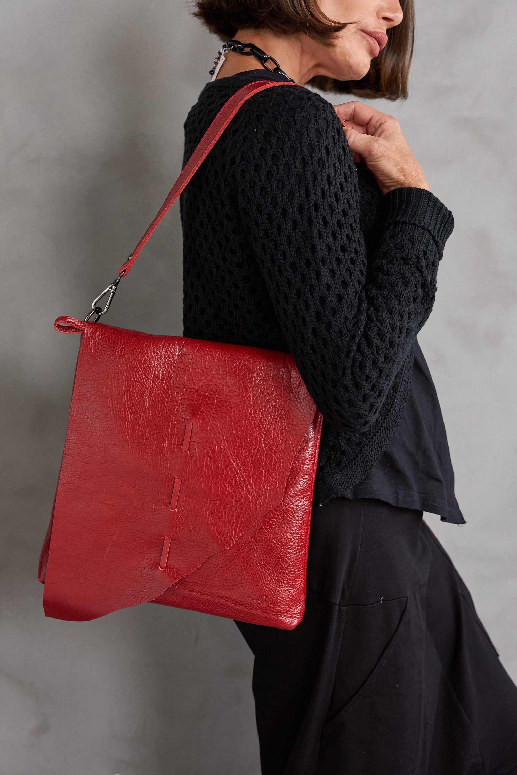 Red asymmetric cut side leather bag