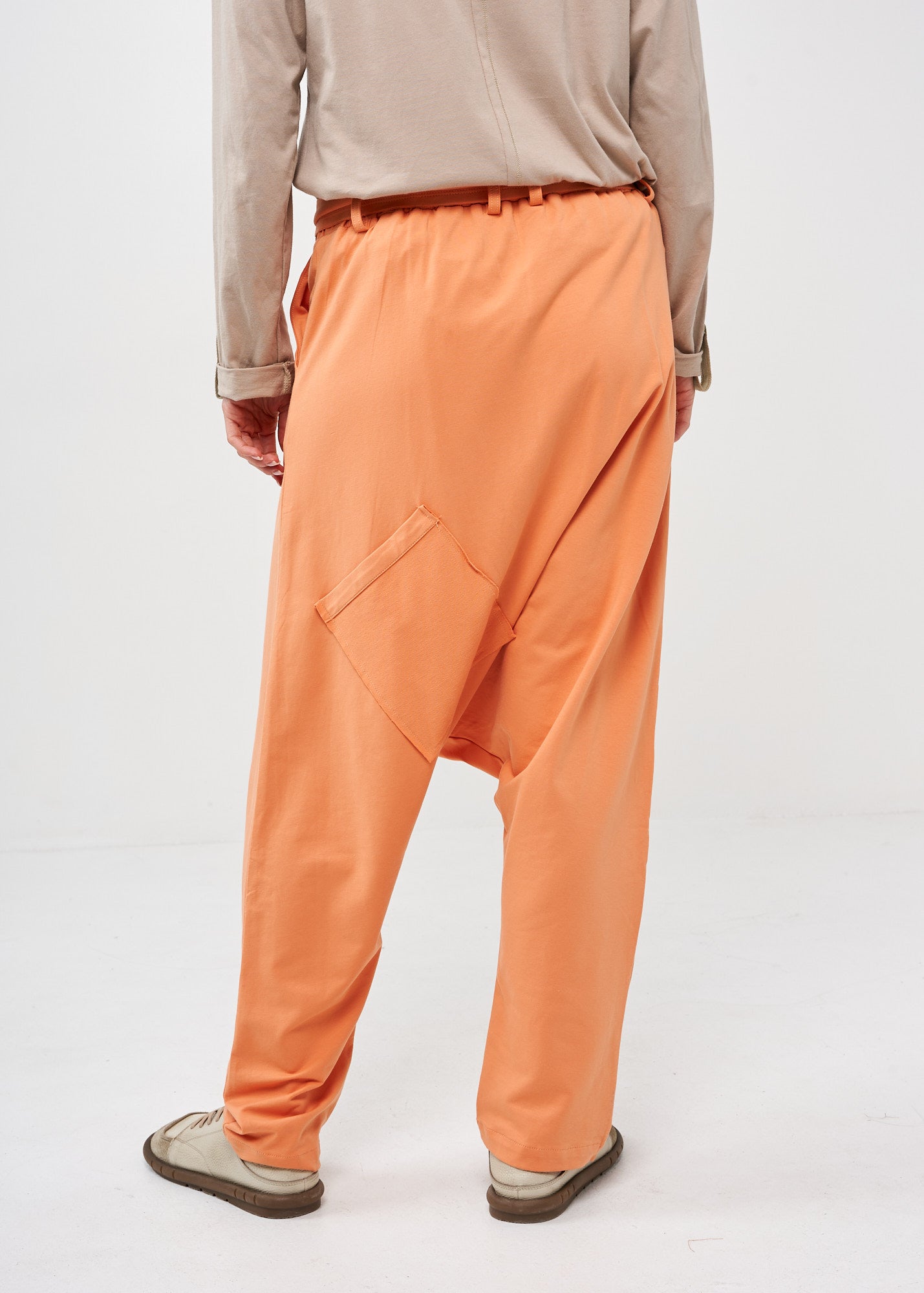 Pants with pockets and an orange belt