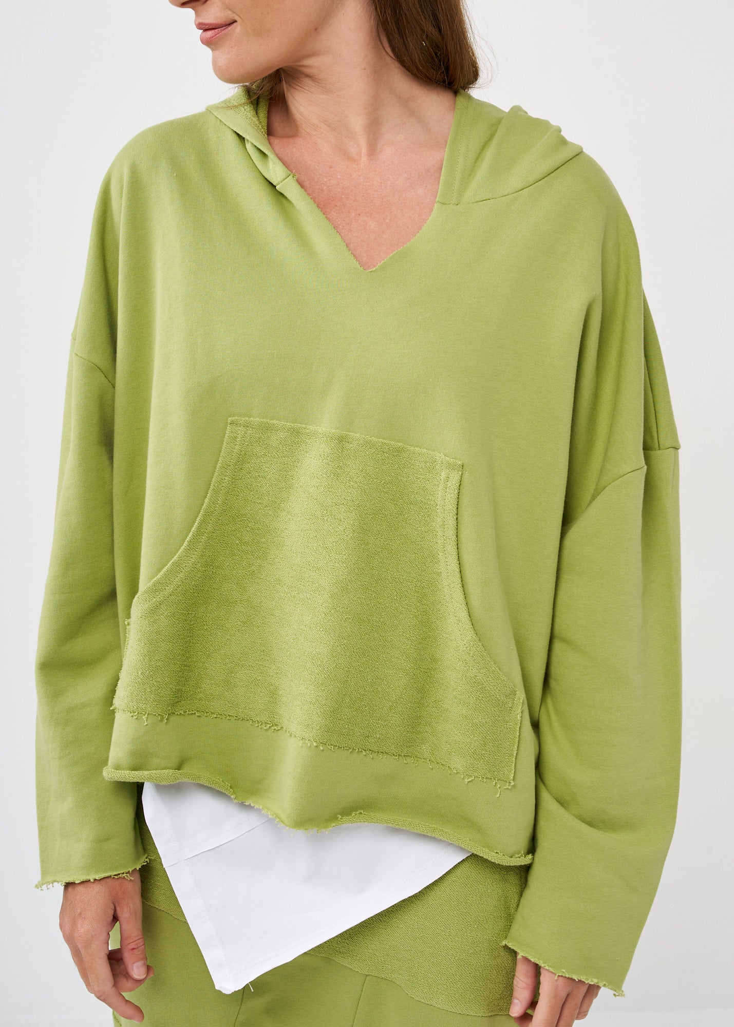 Oversized sweatshirt with a hood and a large green pocket