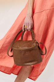 A small leather bag with a handle and a brown color combination