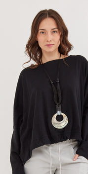 Handcrafted necklace rows of shell straw combined with black leather