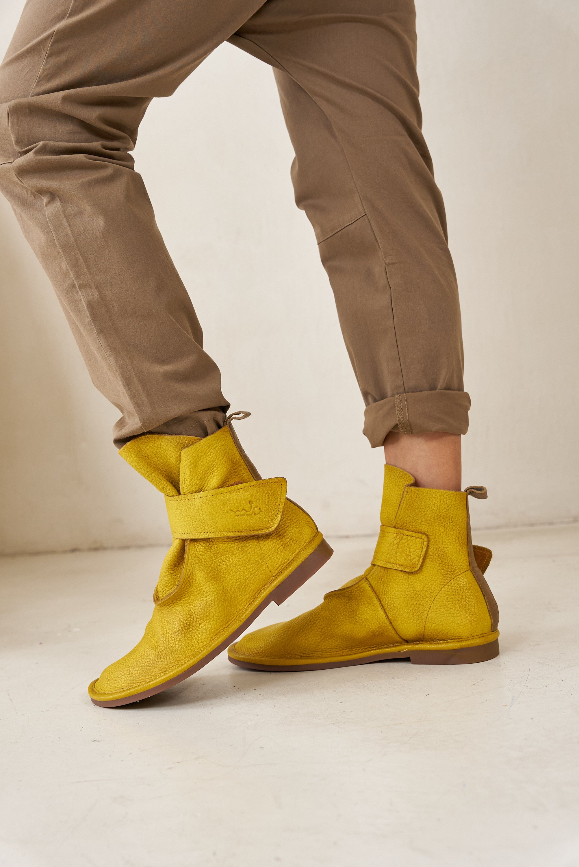 Soft leather ankle boots with yellow velcro closure