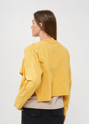 A thin top with a mustard wrapped scarf