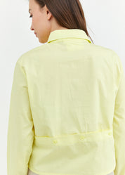 A button-down shirt is getting ready for a yellow short