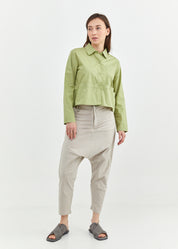 A button-down shirt is getting ready for a light green short