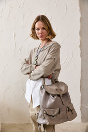 Large leather and canvas backpack with dark brown front pockets