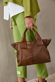 A square side bag combining brown leather and nylon