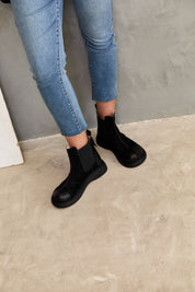 Leather ankle boots with a prominent rubber seam on the sides, black