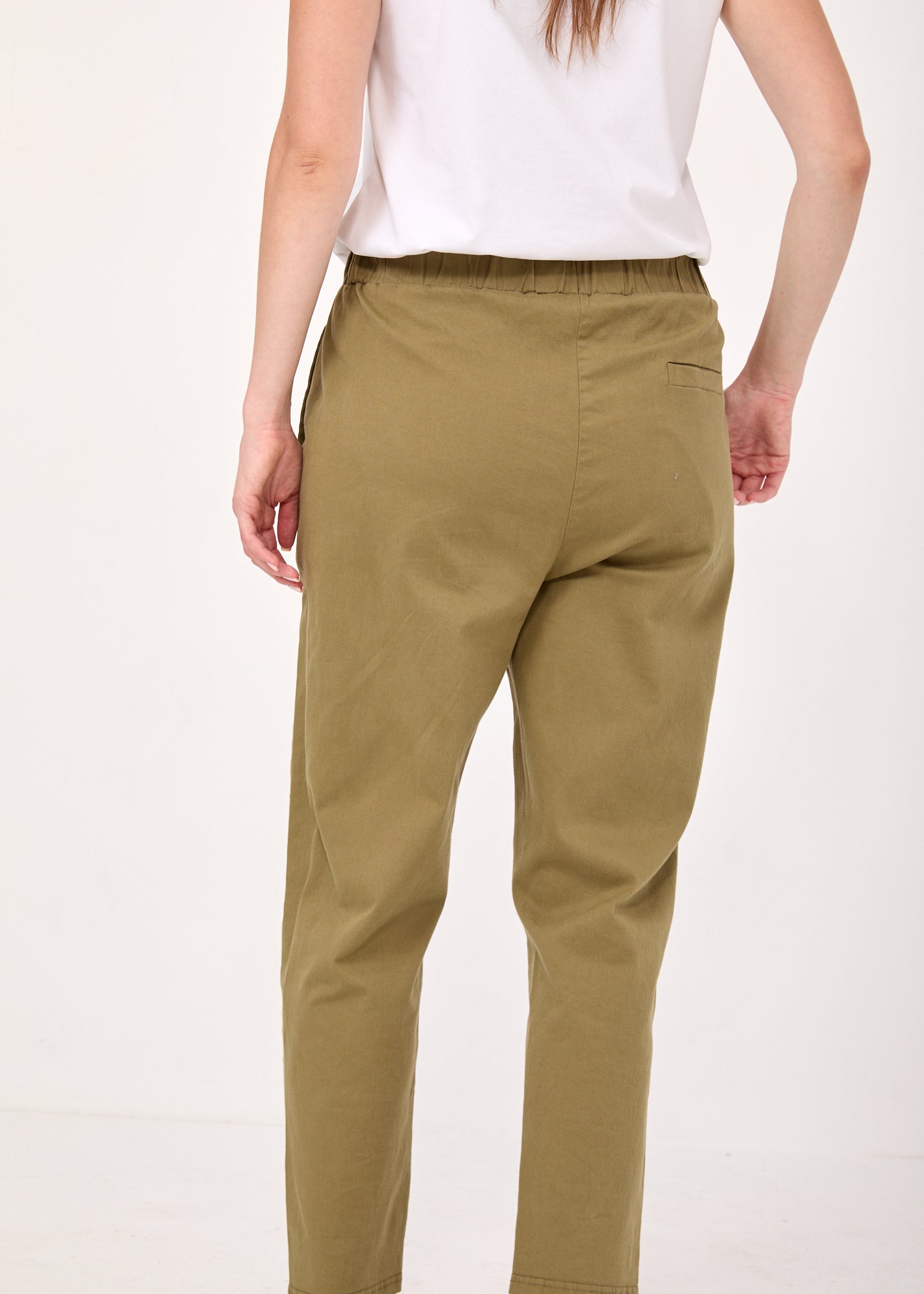 Pants with a seam in the middle and a green classic patch