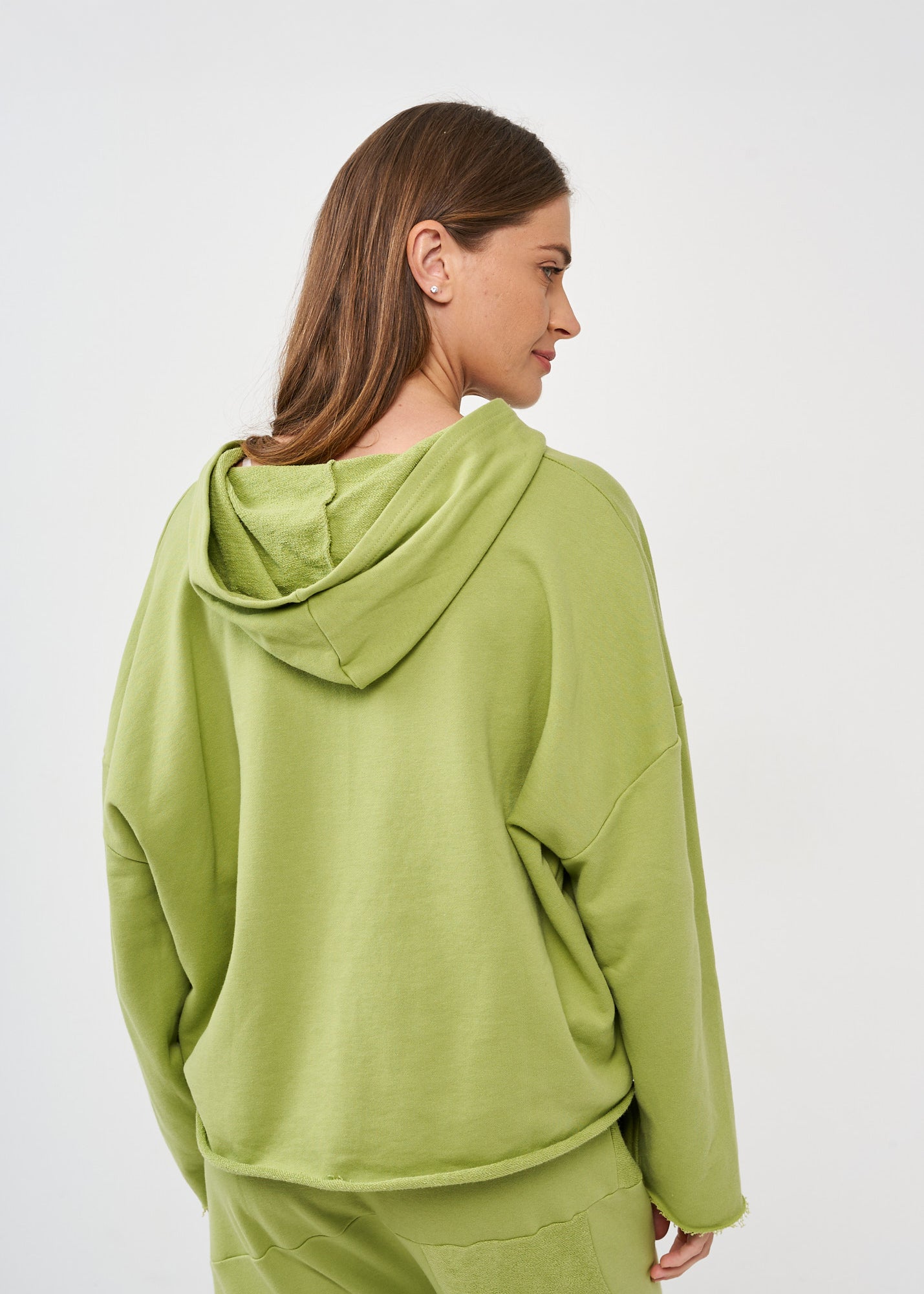 Oversized sweatshirt with a hood and a large green pocket