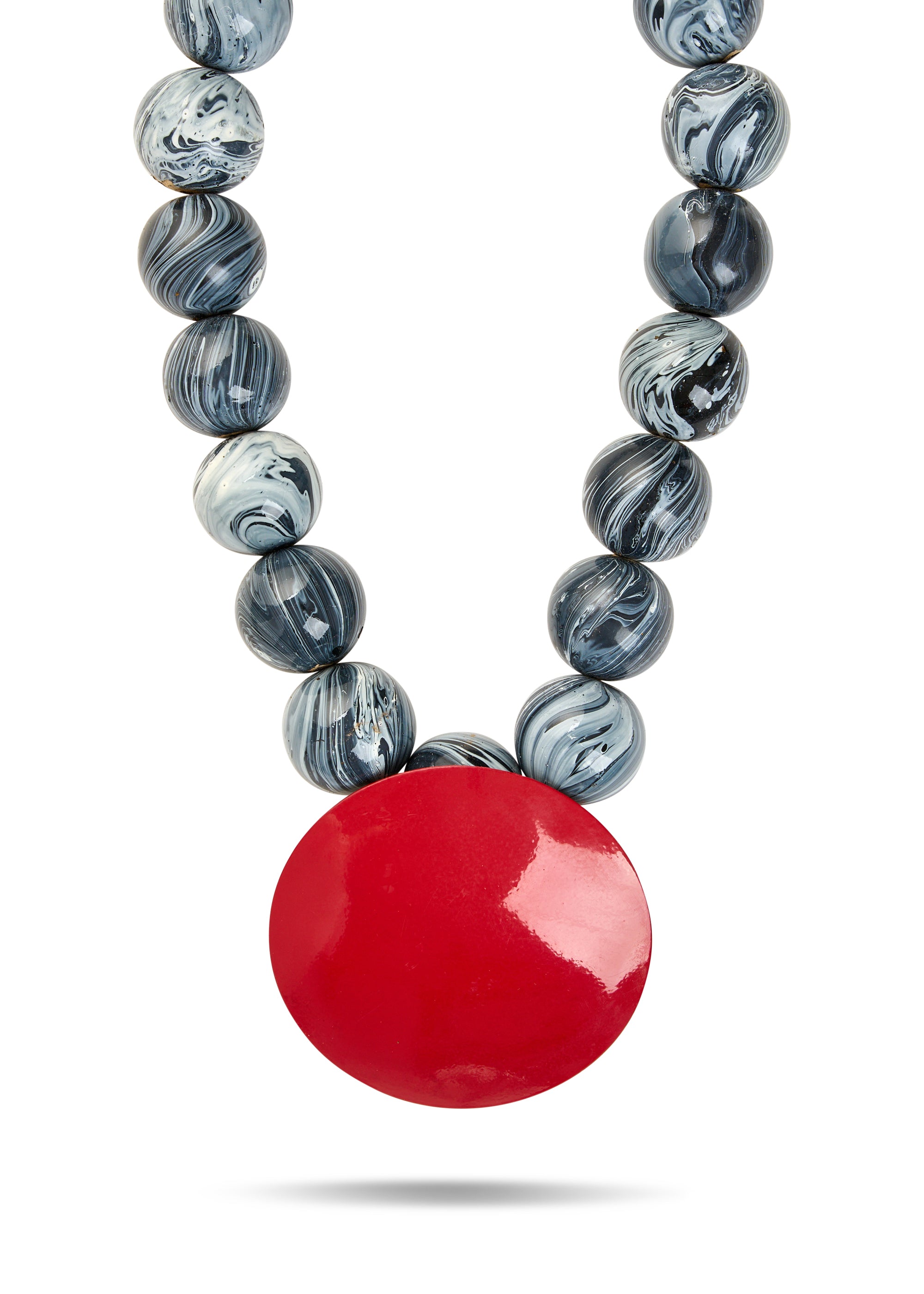 A necklace of wooden beads and a large red disc