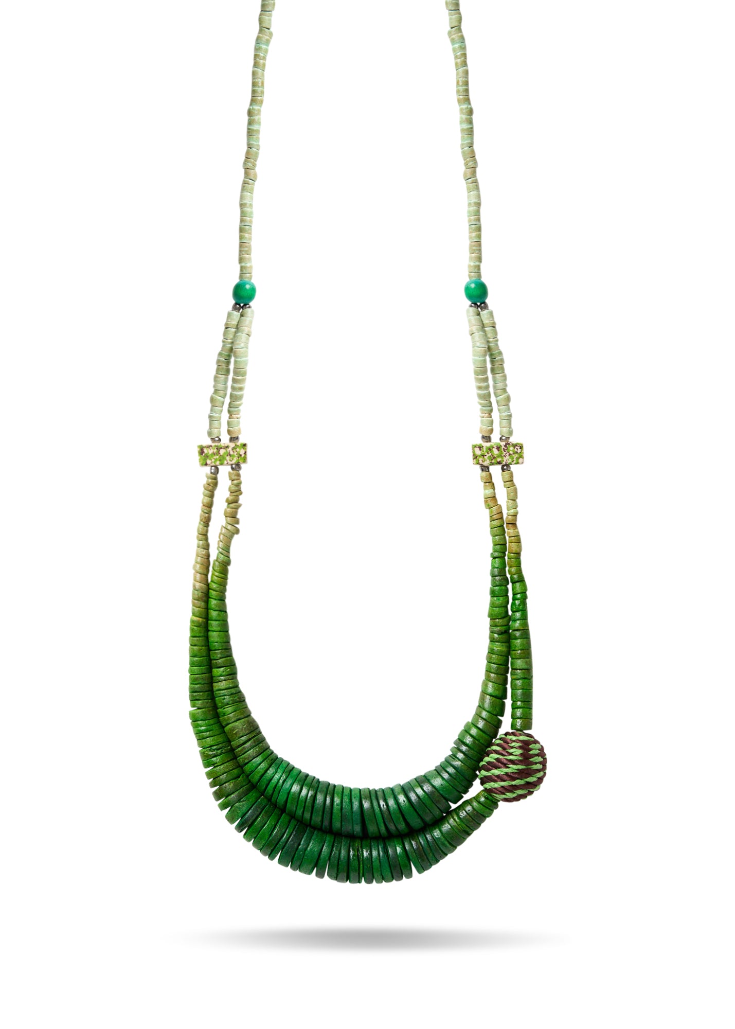 A necklace of coconut disks and a green wrapped bead